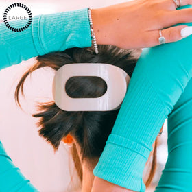 TELETIES next to hand showing large size and capacity for thick hair
