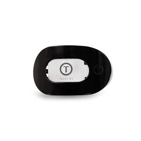 TELETIES flat round clip front view showing sleek jet black profile and secure hold