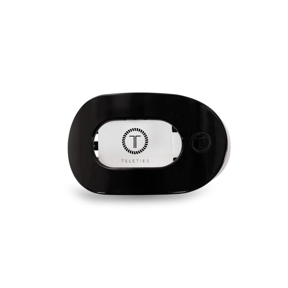 TELETIES flat round clip front view showing sleek jet black profile and secure hold