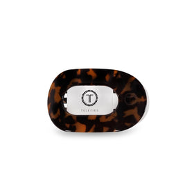 TELETIES flat round clip front view showing tortoise finish and sleek profile benefit comfort