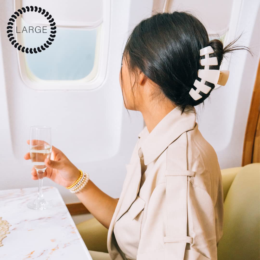 TELETIES clip securing a thick hair updo for stable, comfortable styling