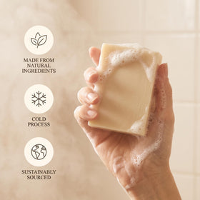 Terra Lotus artisan hand-pouring soap into molds emphasizing small-batch craftsmanship and consistency