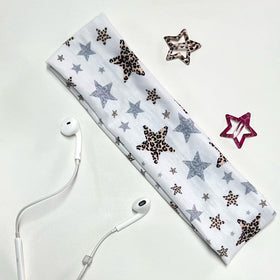 TERSE headband beside notebook for scale showing true size and versatile wear