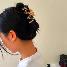 Textention clip securing a full updo illustrating strong grip for thicker hair