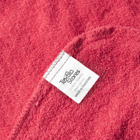 Textila button and loop closure detail illustrating secure fit and slip-resistant benefit while drying