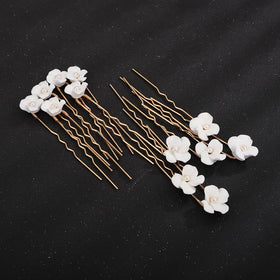 Teyglen close-up of white flower on gold pin highlighting handmade detail and texture