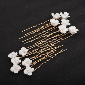 Teyglen gold hairpin placed in bridal updo demonstrating secure hold and sparkle