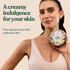 200 ml The Body Shop Almond Milk Body Butter beside a ruler and hand to show scale and travel-friendly size
