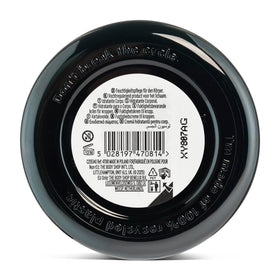 The Body Shop open jar revealing creamy body butter texture that melts on skin