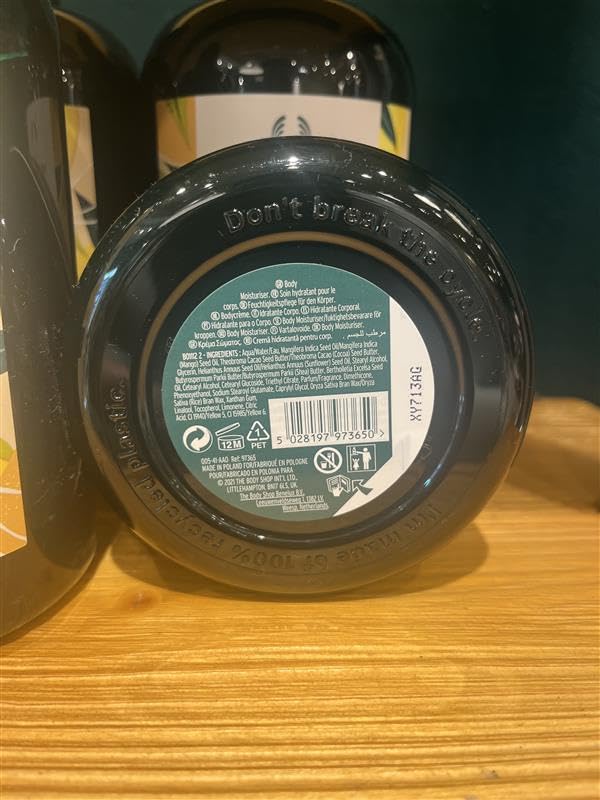 Applying The Body Shop mango body butter to elbow for targeted dry skin care