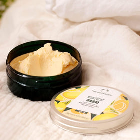 The Body Shop mango body butter being smoothed on skin to soften and nourish