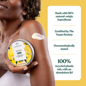The Body Shop mango body butter next to a hand to show compact travel size
