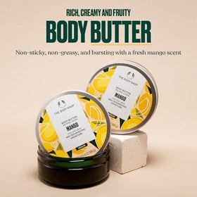 The Body Shop mango body butter 200 ml next to a smartphone for size reference