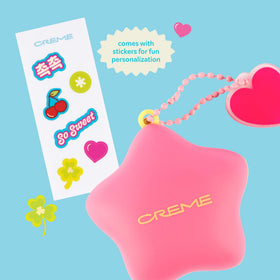 The Crème Shop in hand applying balm for instant lip comfort