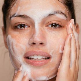 Close-up of creamy foam texture from The Face Shop showing mild exfoliating particles