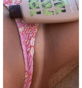 Hand holding The Fox Tan 120 mL bottle to show travel-friendly scale and convenience