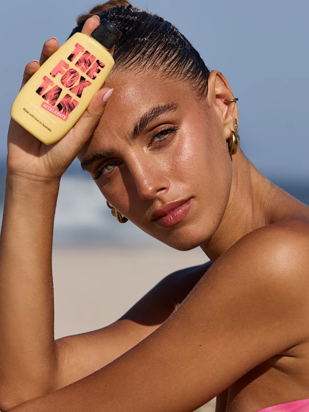 THE FOX TAN bottle in hand demonstrating 90ml scale and travel-friendly convenience benefit