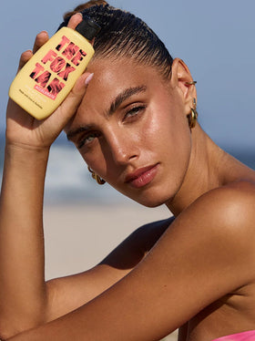 THE FOX TAN bottle in hand demonstrating 90ml scale and travel-friendly convenience benefit