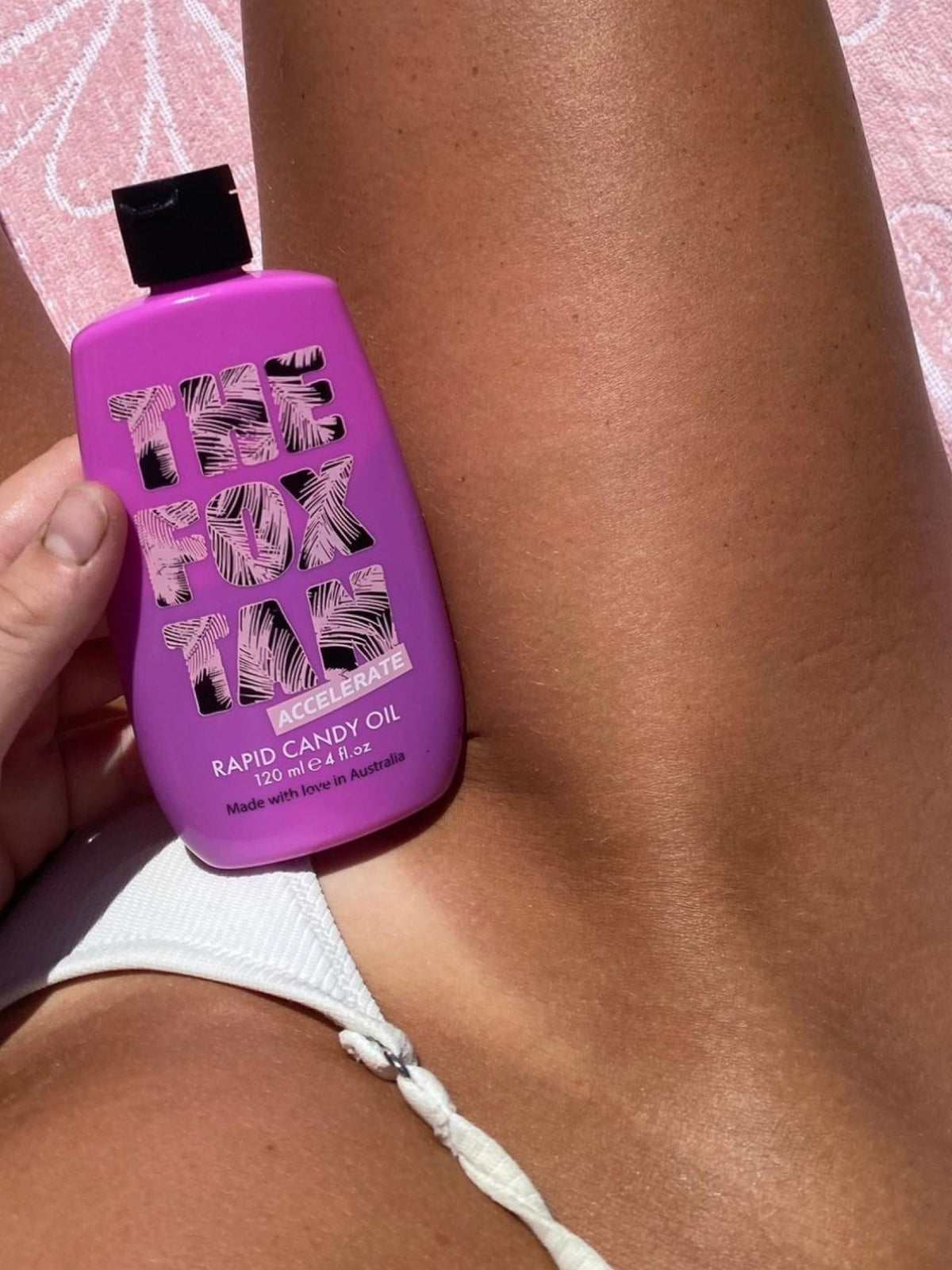 120mL bottle in hand to show The Fox Tan scale, highlights travel-friendly size