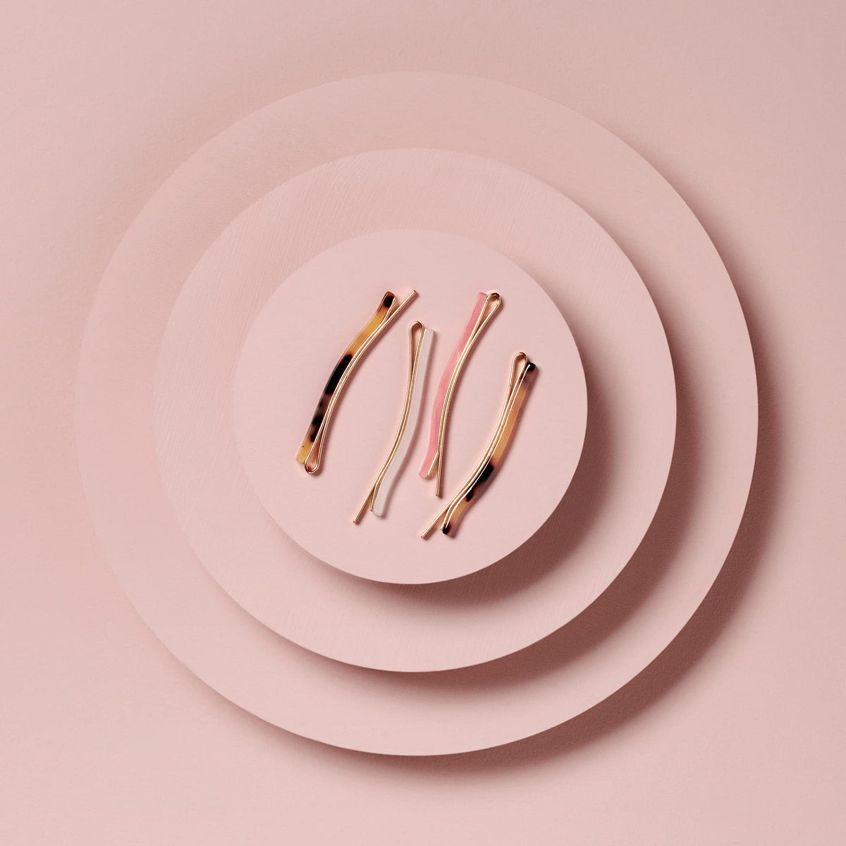 The Hair Edit lifestyle flatlay with pins on a vanity conveying effortless styling