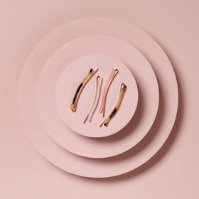 The Hair Edit lifestyle flatlay with pins on a vanity conveying effortless styling