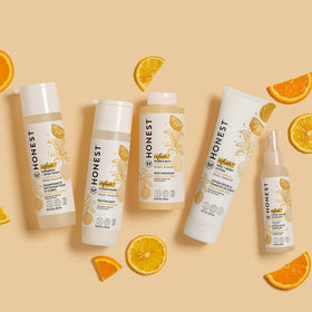 The Honest Company bottle in hand showing 4 fl oz travel-friendly size