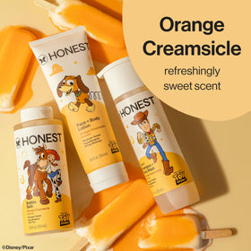 The Honest Company bottle next to towel showing family‑friendly size benefit