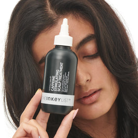 The INKEY List bottle on a bedside table to suggest convenient overnight routine