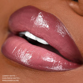The Lip Bar lifestyle wrist shot with Curlfriend showing wearable color on the go
