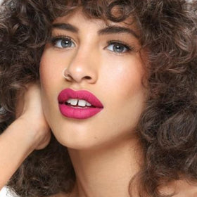 the lip bar fuchsia shade swatch on arm showing true color and high-pigment payoff benefit
