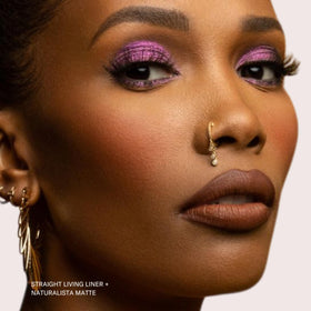 The Lip Bar Low Key on lips showing deeper brown shade and high-pigment payoff