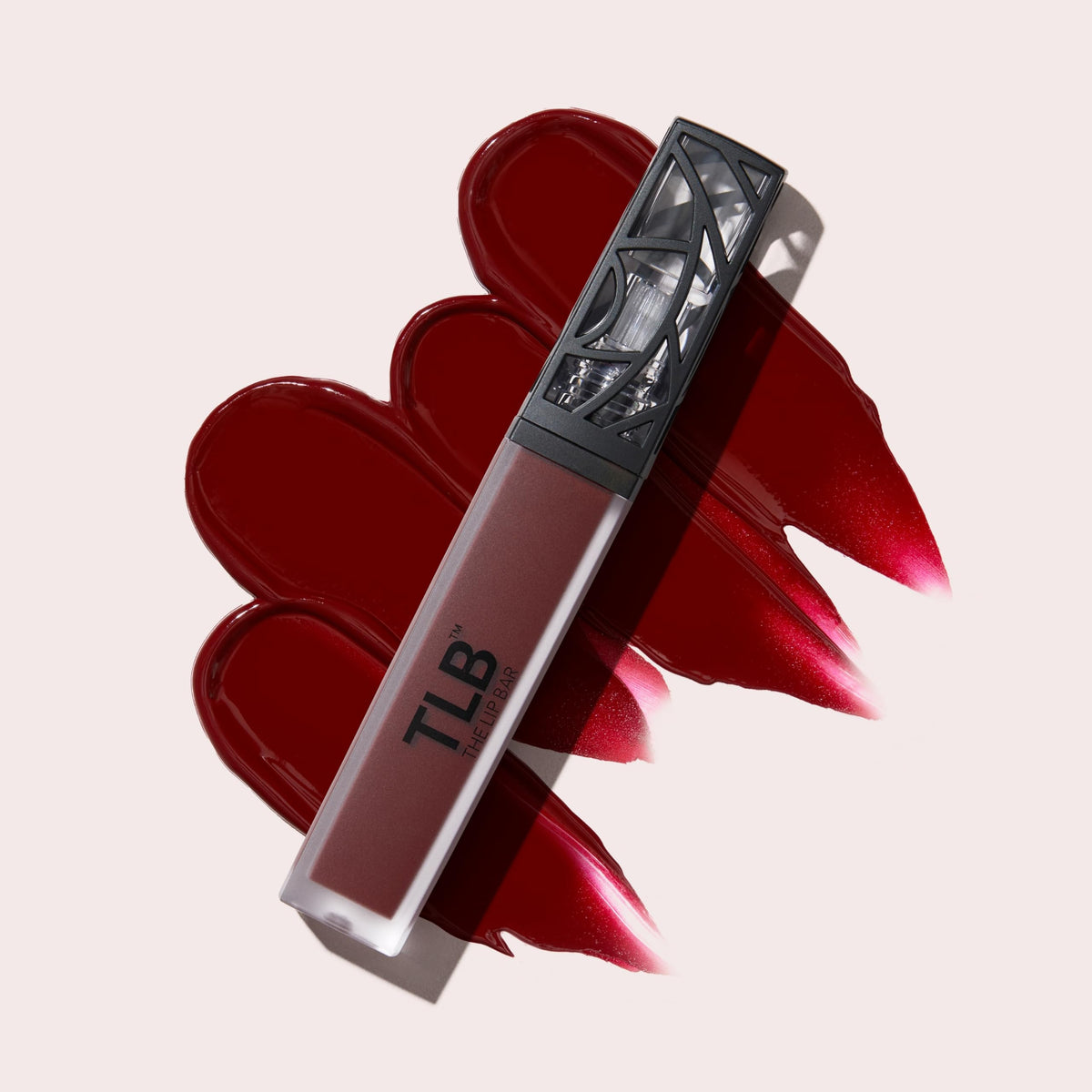 Model wearing The Lip Bar Mastermind deep blood red showcasing bold color and confident look