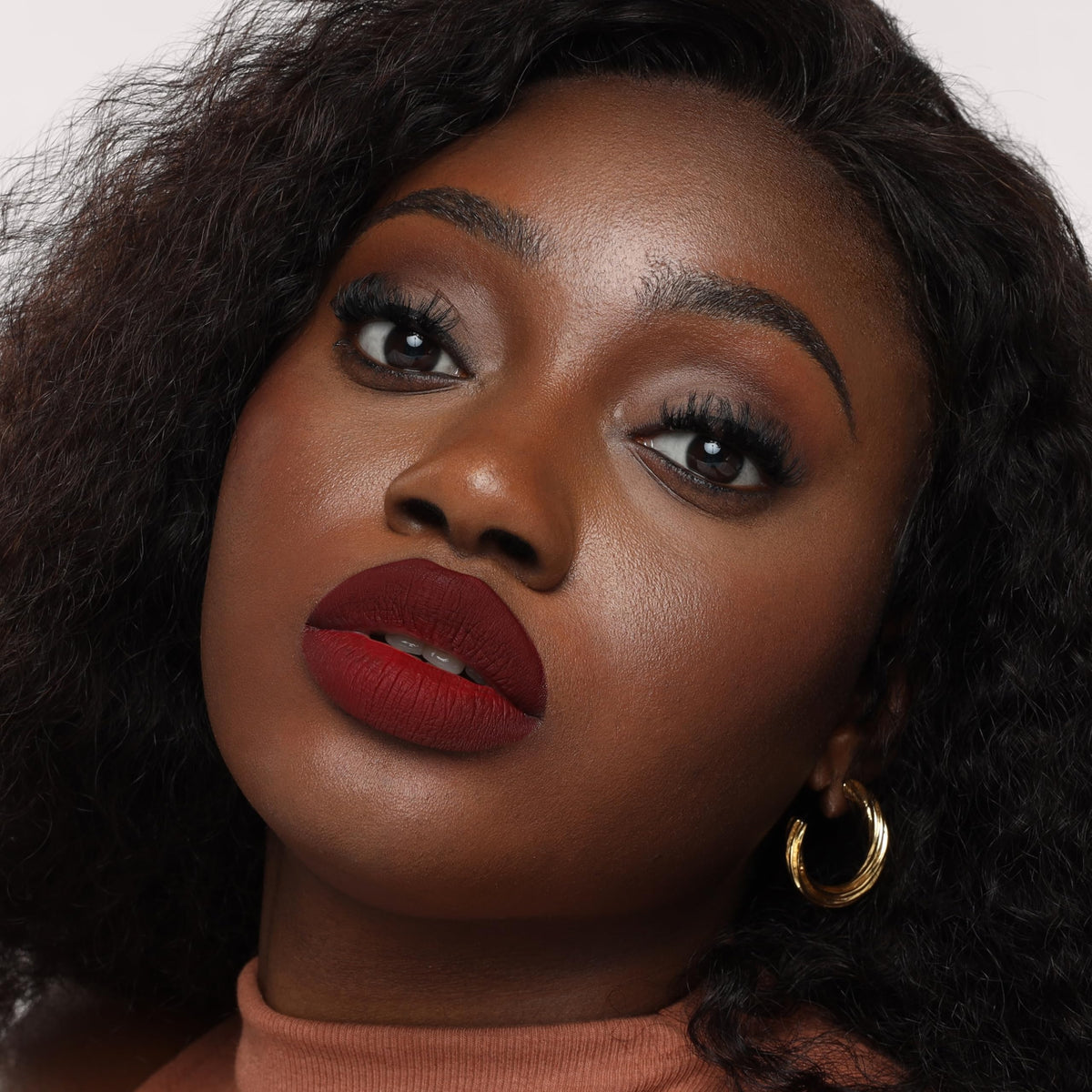 The Lip Bar Mastermind beside ruler indicating .24 fl oz size and travel-friendly convenience