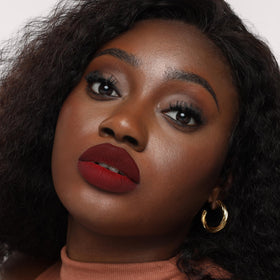 The Lip Bar Mastermind beside ruler indicating .24 fl oz size and travel-friendly convenience