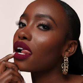 The Lip Bar Muse beside a ruler to show .24 fl oz size, travel-friendly convenience