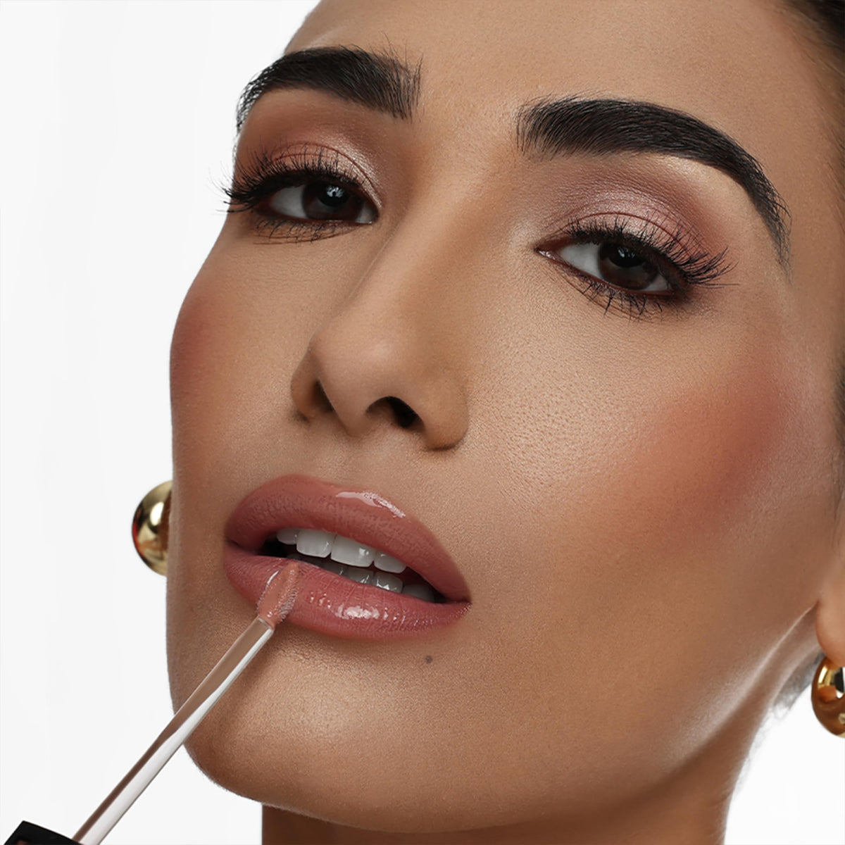 The Lip Bar gloss layered over matte lipstick for added dimension
