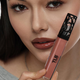 The Lip Bar gloss next to coin showing compact travel-ready size
