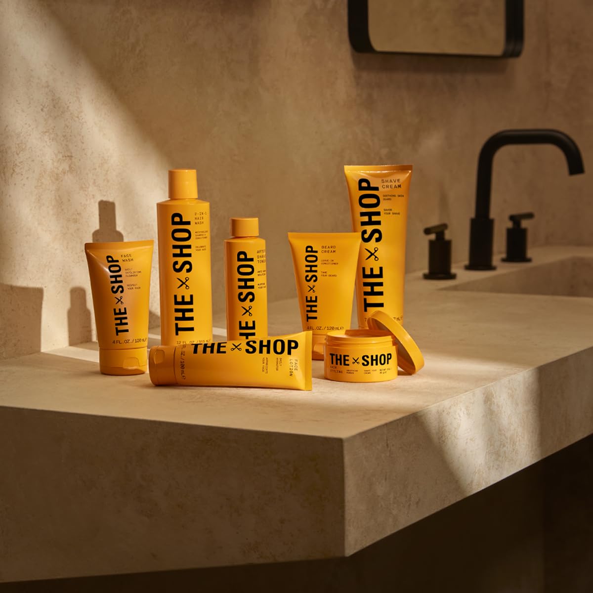 The Shop Uninterrupted bottle held in hand showing 12 fl oz travel-friendly size