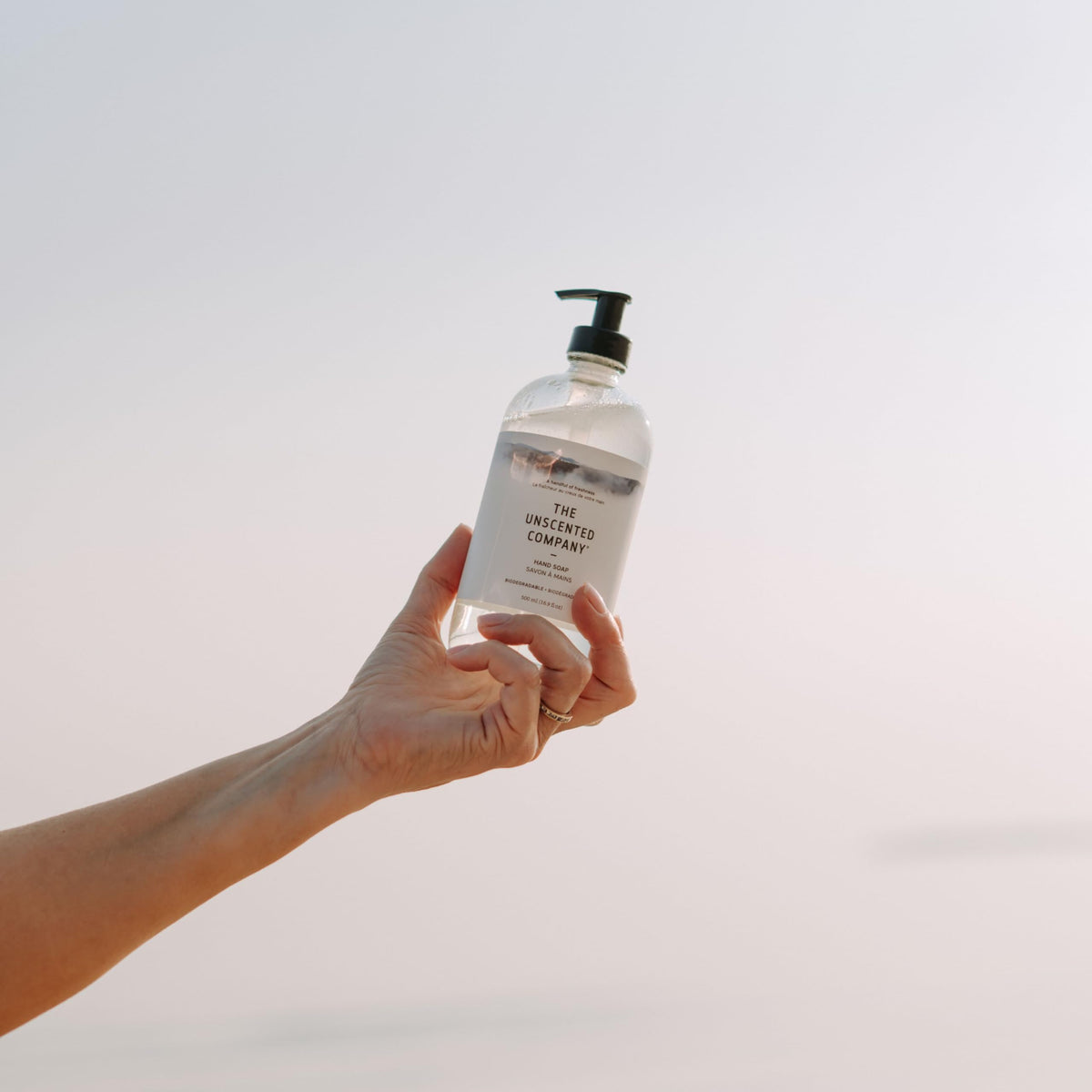 The Unscented Company next to a common household item showing 16.9 fl oz scale