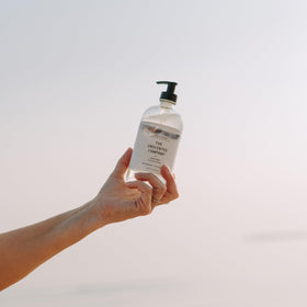 The Unscented Company next to a common household item showing 16.9 fl oz scale