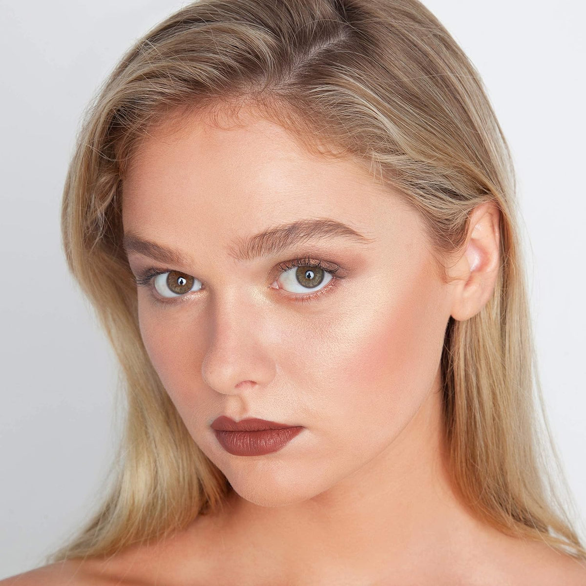 theBalm Bahama Mama being applied to cheek with brush showing sculpting benefit