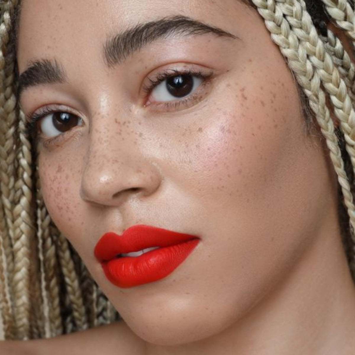 The Lip Bar ingredient label highlighting jojoba oil and vitamin E benefits