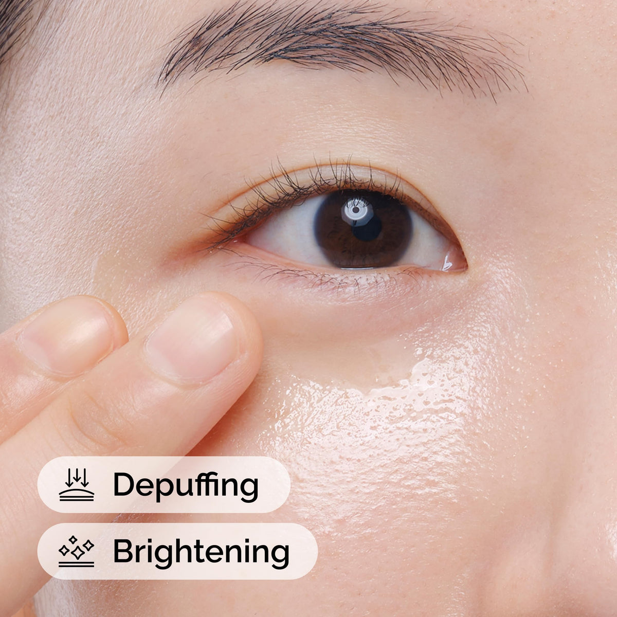 Applying The Ordinary serum to under-eye area, portraying depuffing benefit