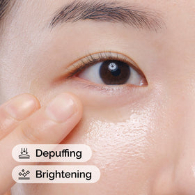 Applying The Ordinary serum to under-eye area, portraying depuffing benefit