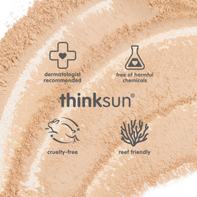 THINK applying brush-on sunscreen to child's cheek for easy reapplication