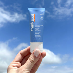 Thinksport applied to model's face showing lightweight wear and makeup-friendly base