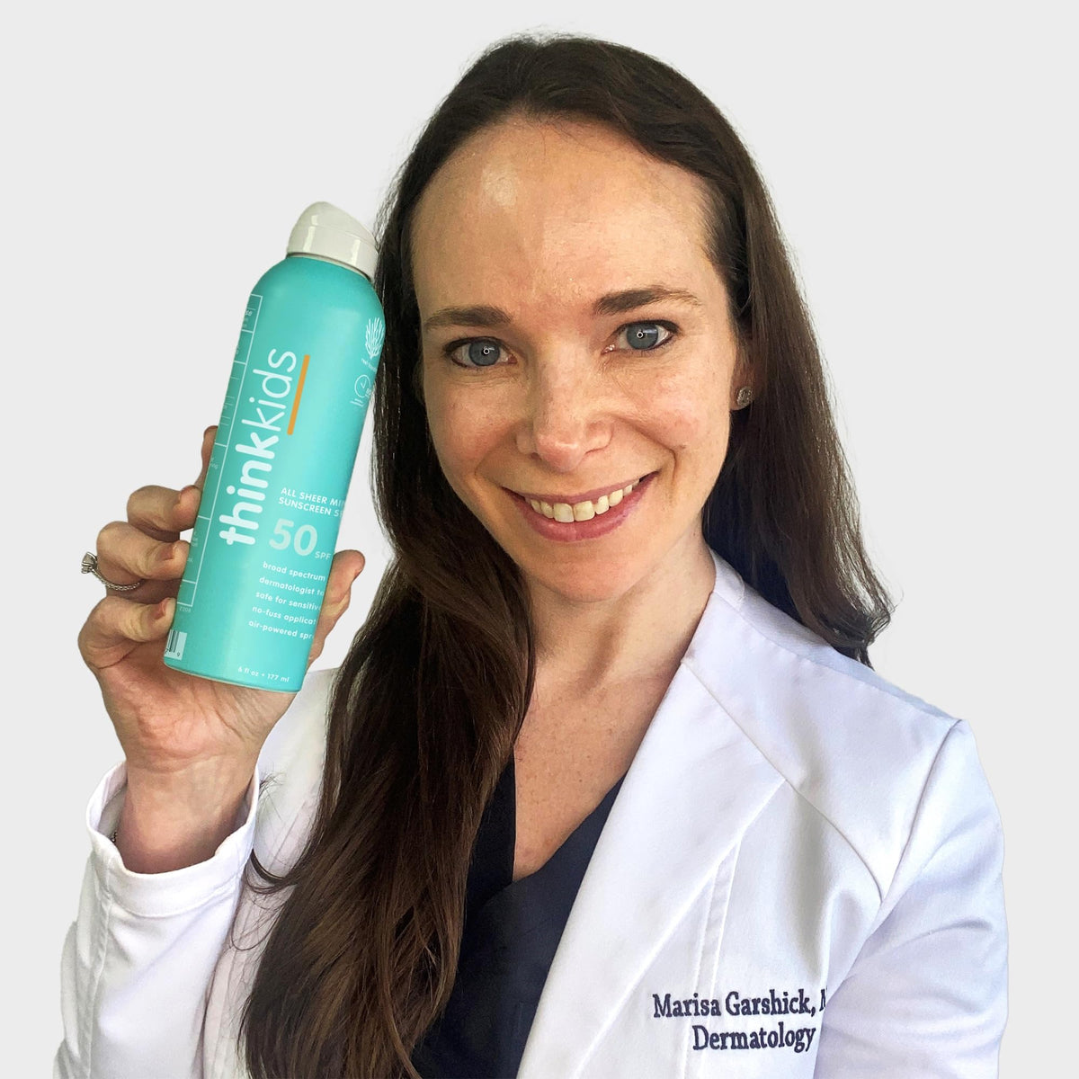 Parent applying Thinksport spray to child arm for fast on-the-go coverage
