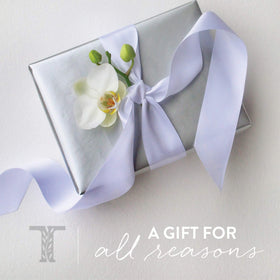 Thymes Kimono Rose bottle on bathroom shelf styled for a calming self-care atmosphere