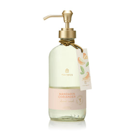 Thymes bottle front view showing elegant mandarin coriander label and benefit of refreshed hands