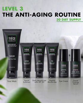 Tiege Hanley products laid out to display included cleanser, scrub, moisturizers, serum, eye cream